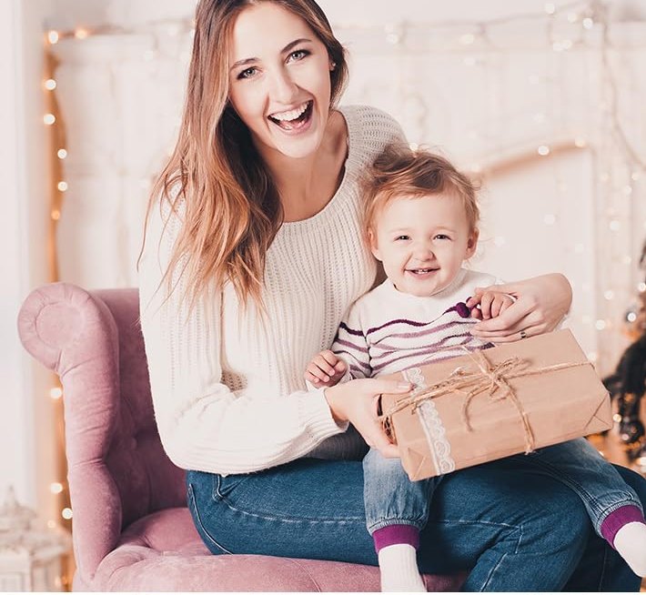 Parent and toddler together with a gift